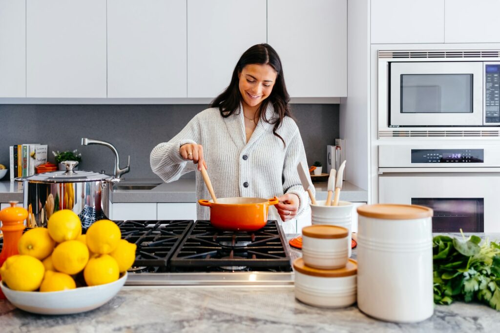 Mujer cocinando en una cocina luminosa